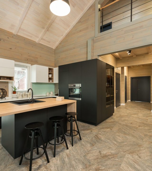 A stylish modern kitchen featuring wooden accents and minimalist design.
